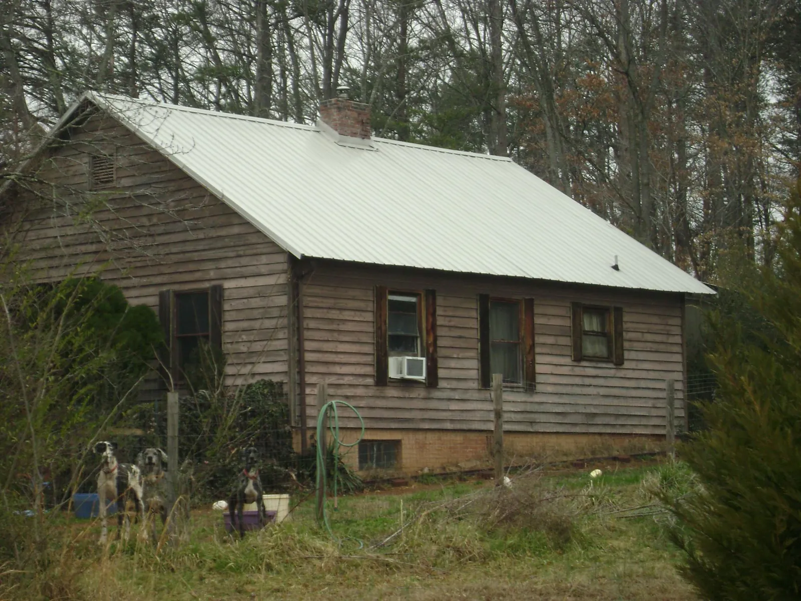 White metal roof on an old wood sided farmhouse, from a Metal Roof Installation job in Crittenden